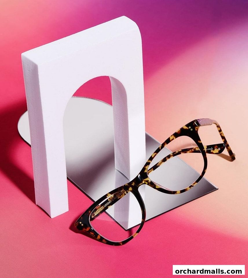 Stylish tortoise shell eyeglasses displayed with modern decor and a gradient background.