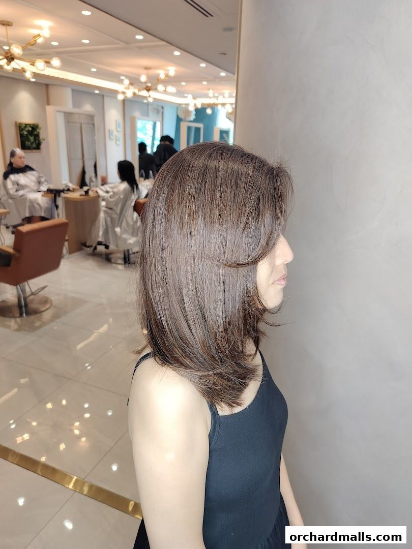 A woman with a fresh haircut and style at AUBE Beauty Salon.
