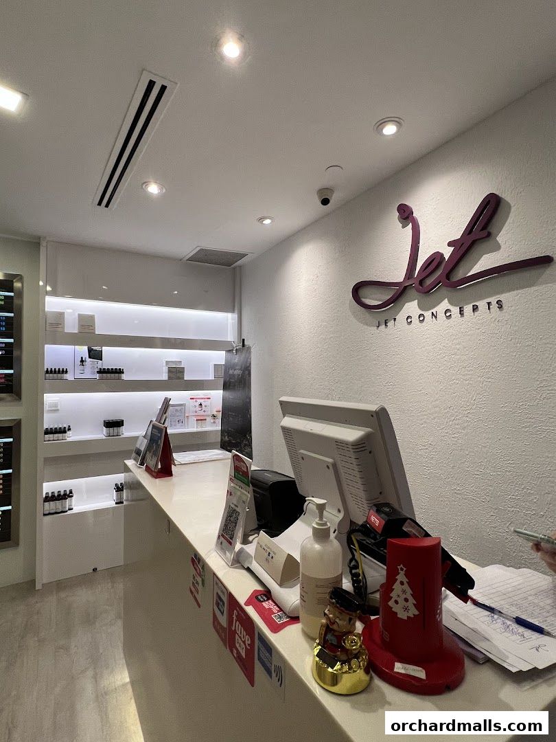 Interior view of a retail shop counter with products displayed on shelves behind.
