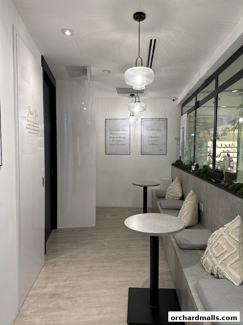 Interior of a modern spa waiting area with comfortable seating and decorative wall art.