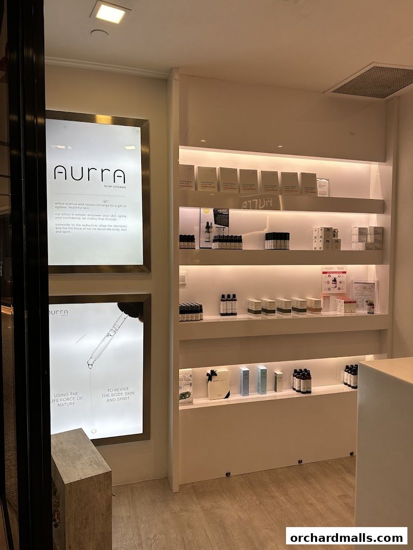 AURRA by Jet Concepts shop front with illuminated signs and shelves of skincare products.