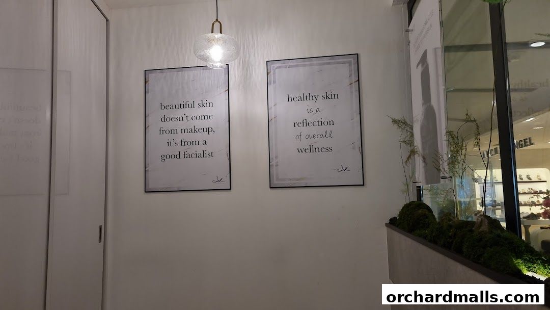 Two framed quotes about skin and wellness hang on a white wall.