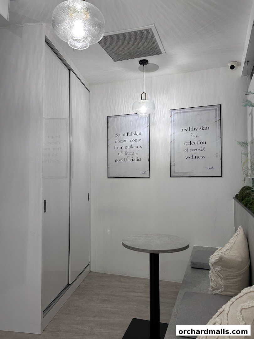 Interior of a modern spa with minimalist decor, featuring quotes on wellness and beauty.