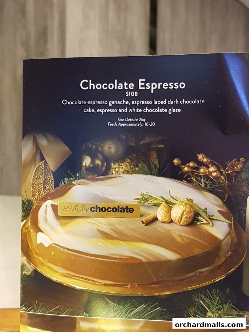 A close-up of a Chocolate Espresso cake with a glossy finish and festive decorations.