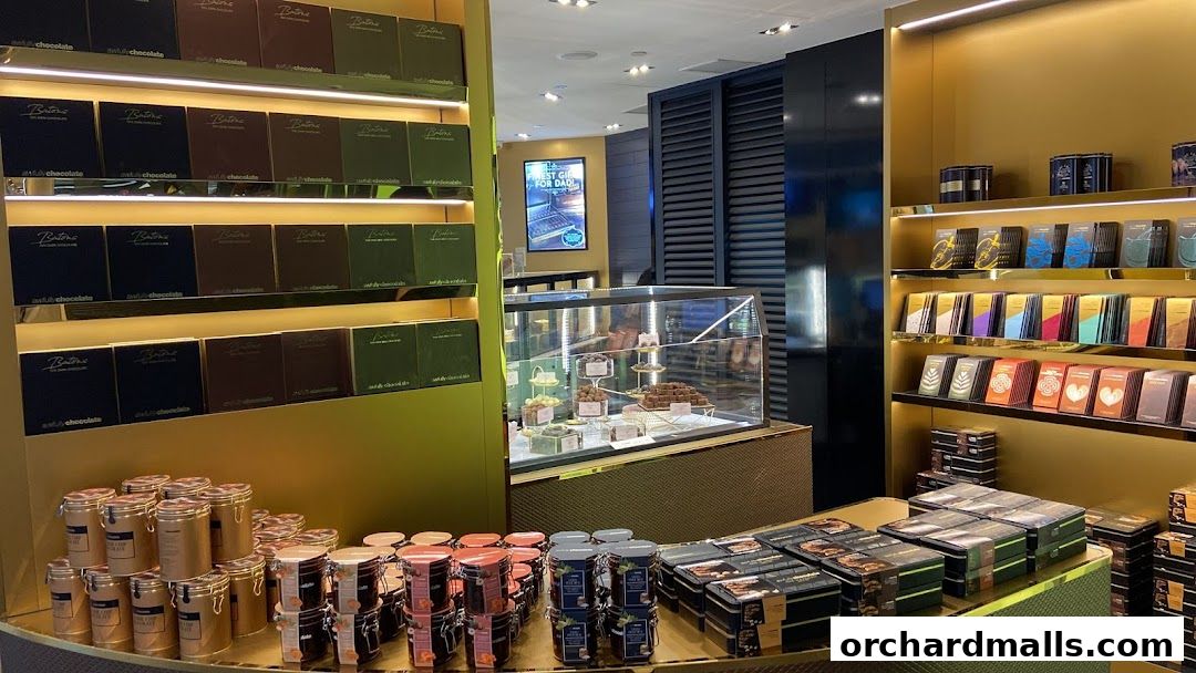 Interior of a luxurious chocolate shop with shelves stocked with various chocolate bars and gift boxes.