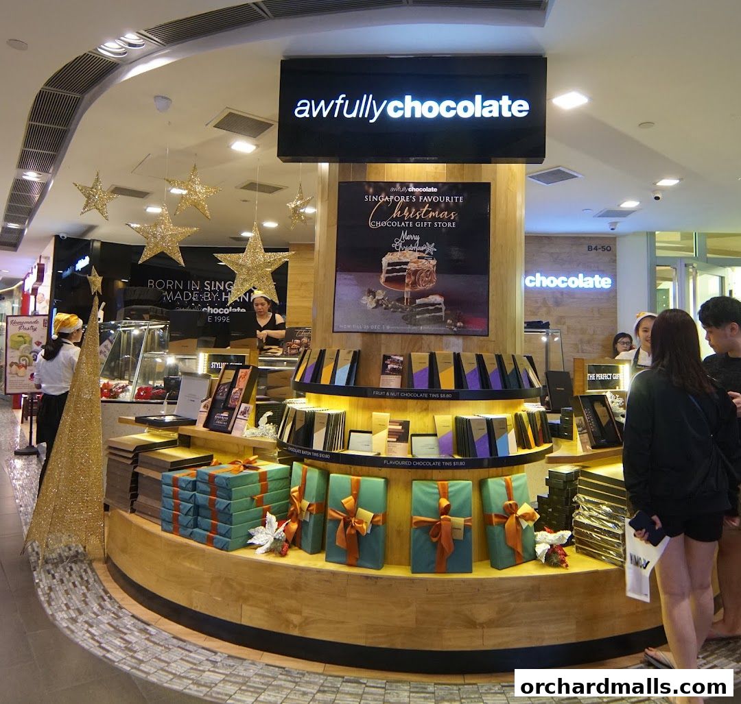 Awfully Chocolate shop interior with Christmas decorations and gift-wrapped chocolates.