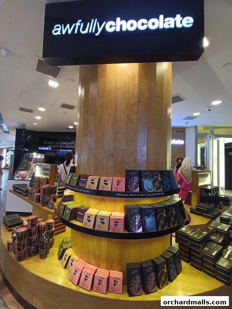 A display of Awfully Chocolate products, featuring various chocolate bars and gift boxes.