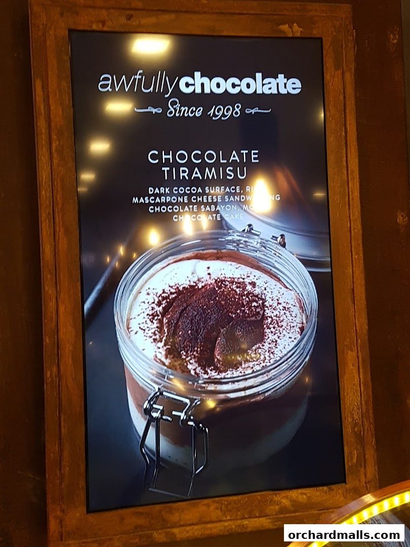 A close-up of a Chocolate Tiramisu dessert in a jar from Awfully Chocolate.