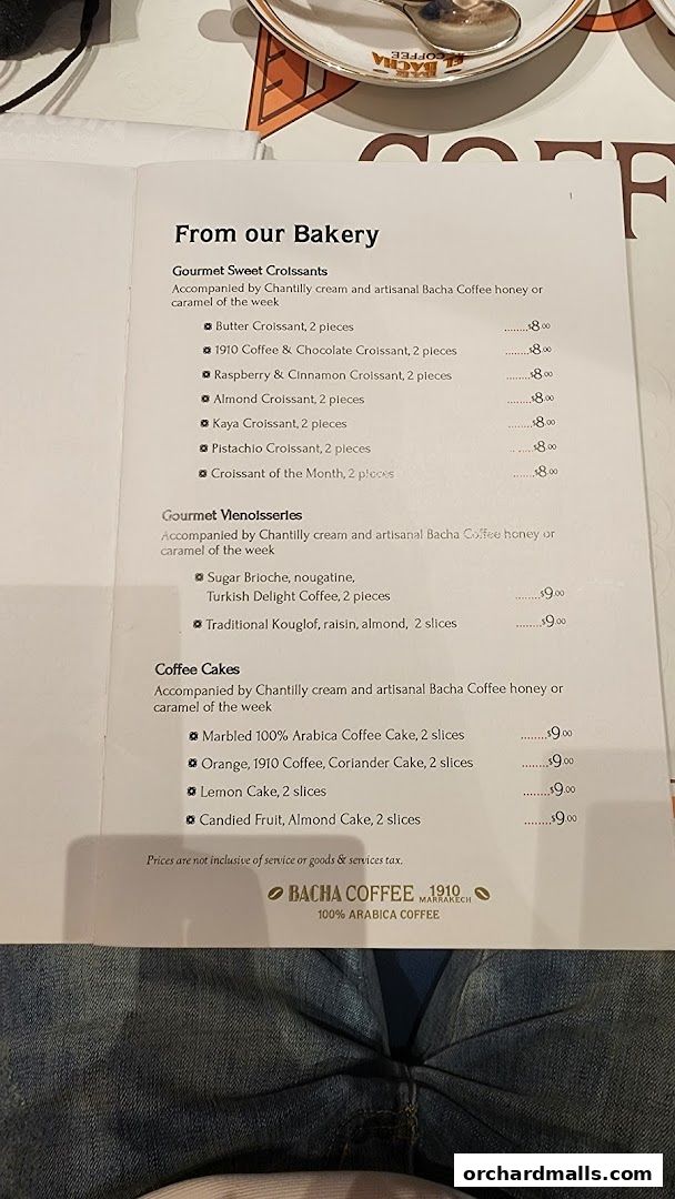 A menu from Bacha Coffee featuring bakery items like croissants and cakes.
