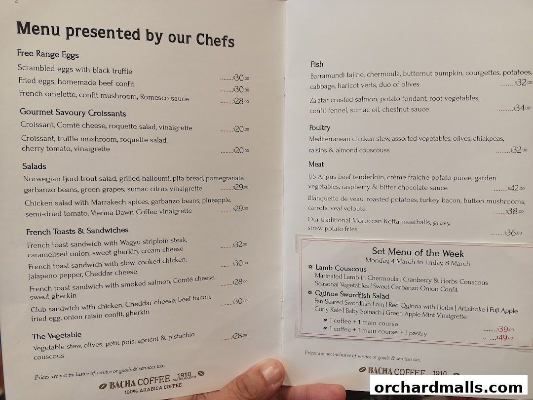A menu from Bacha Coffee featuring various dishes like eggs, croissants, salads, sandwiches, fish, poultry, and meat.