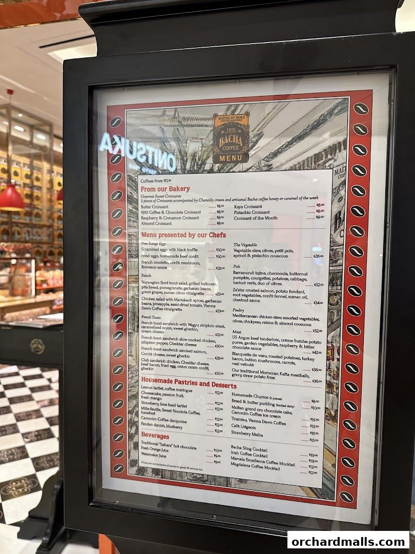 A menu board for Bacha Coffee, showcasing a variety of pastries, desserts, salads, and beverages.