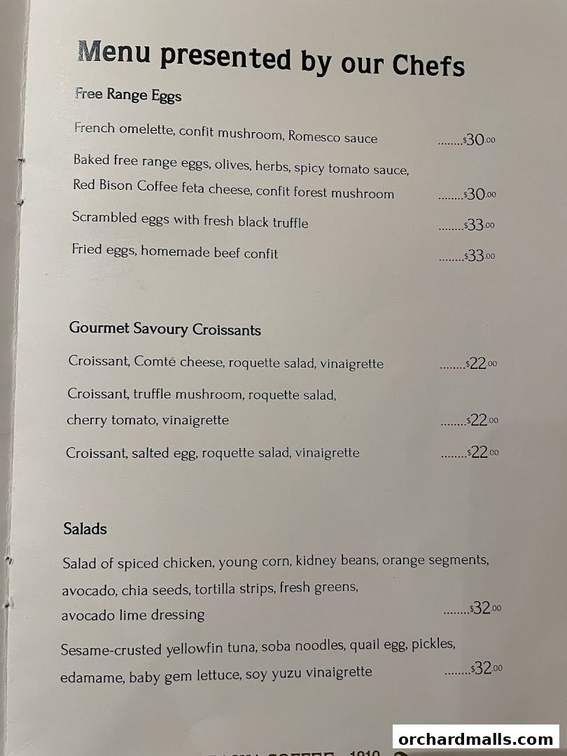 A menu from Bacha Coffee featuring gourmet egg dishes, savory croissants, and fresh salads.