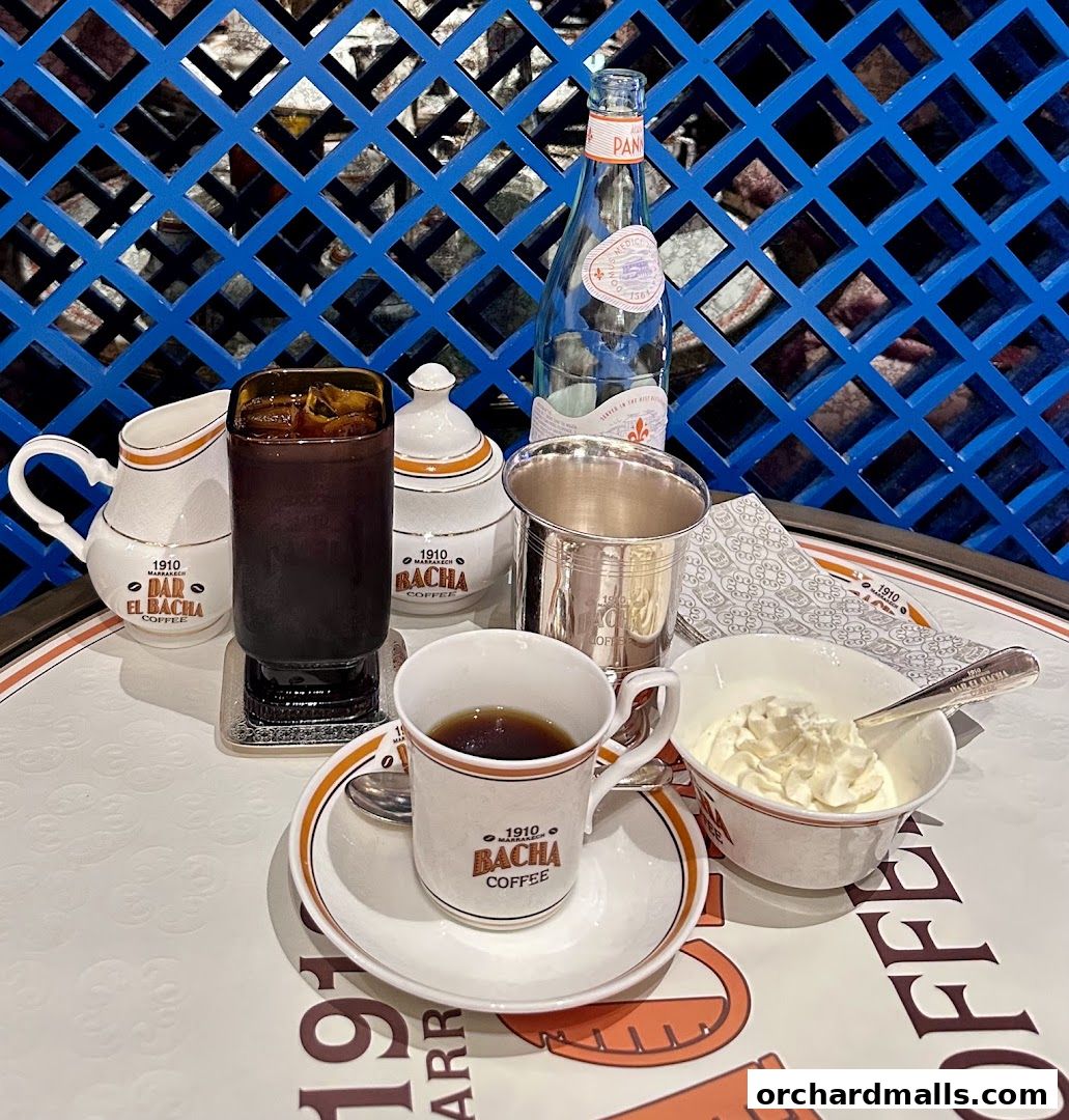 A table setting at Bacha Coffee with coffee, cream, and bottled water.