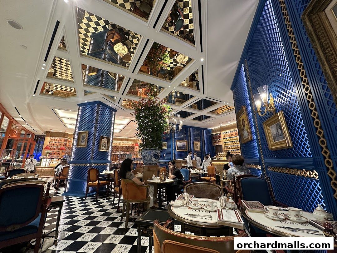 Elegant interior of Bacha Coffee with ornate decor, checkered floors, and patrons enjoying coffee.