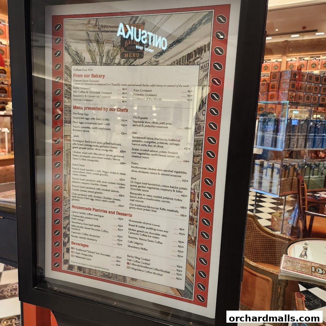 A menu board displaying various coffee, pastry, and meal options from Bacha Coffee.