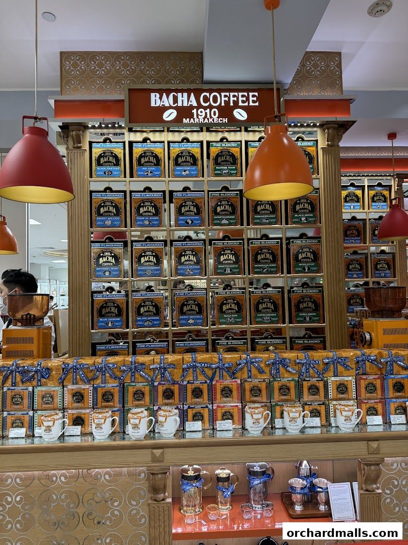 A display of Bacha Coffee products, including coffee tins, cups, and brewing equipment.