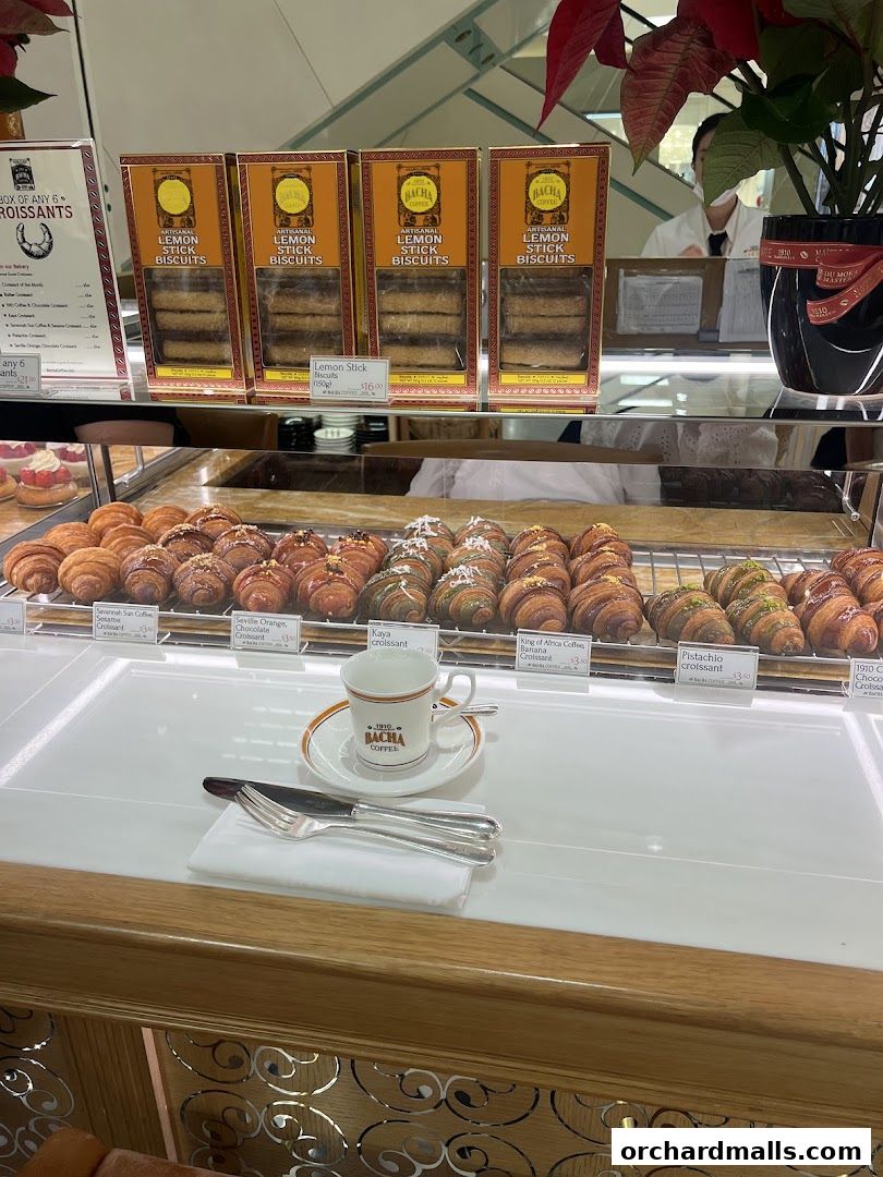 A display case filled with croissants and packaged biscuits at Bacha Coffee.