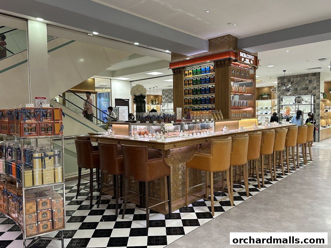 Interior of Bacha Coffee Takashimaya with a coffee bar, seating, and retail displays.