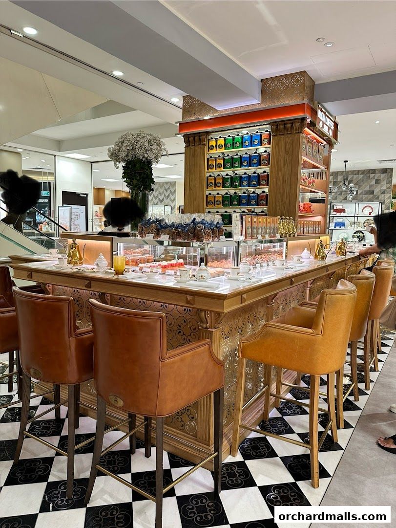 Elegant coffee bar with display of teas, pastries, and seating.