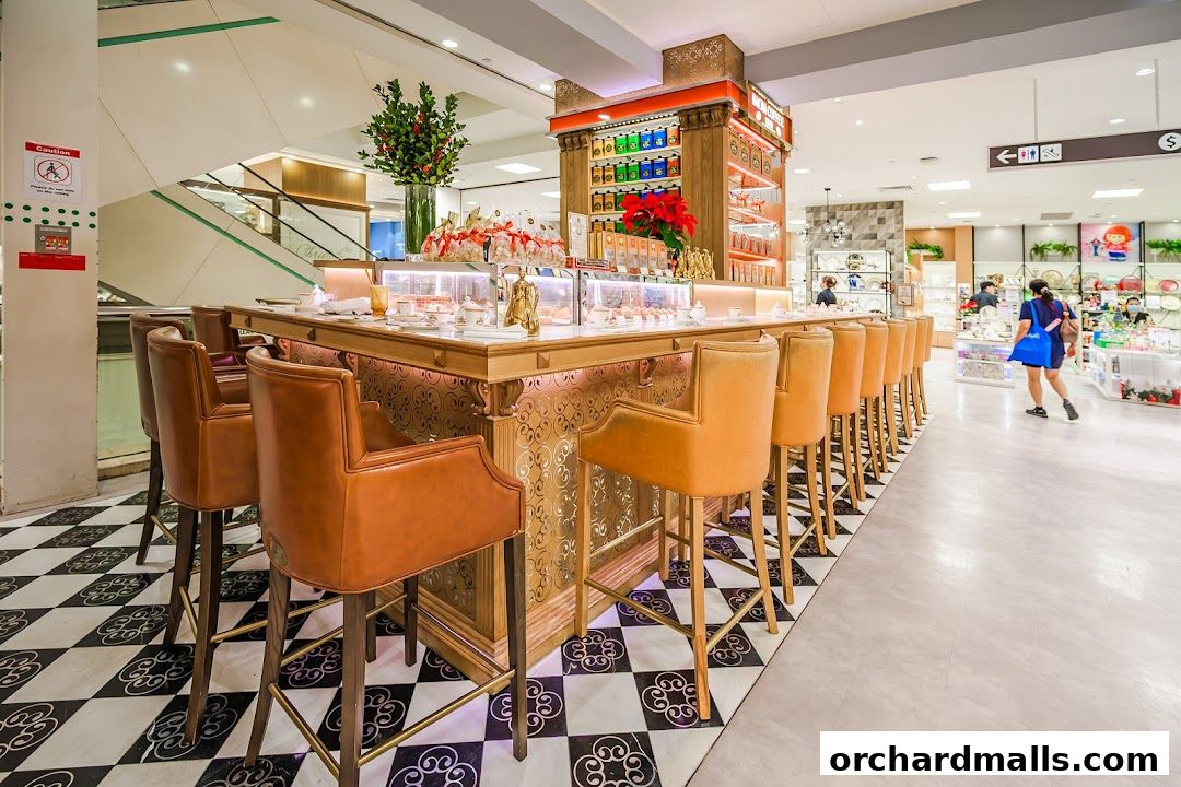 Elegant coffee bar with plush seating and decorative displays in a retail setting.
