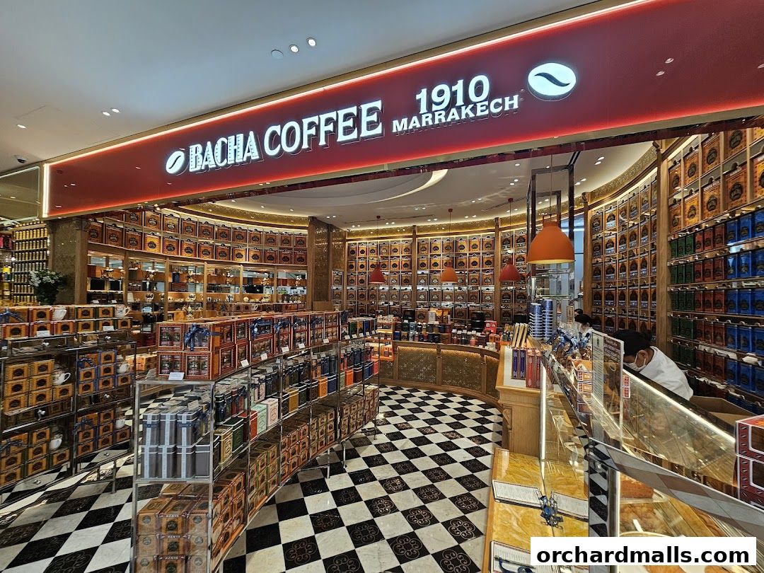 Interior view of Bacha Coffee Takashimaya, showcasing shelves filled with coffee tins and a checkered floor.