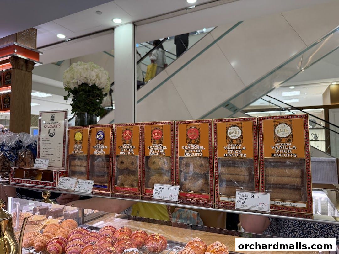 Display of Bacha Coffee biscuits and croissants in a retail setting.