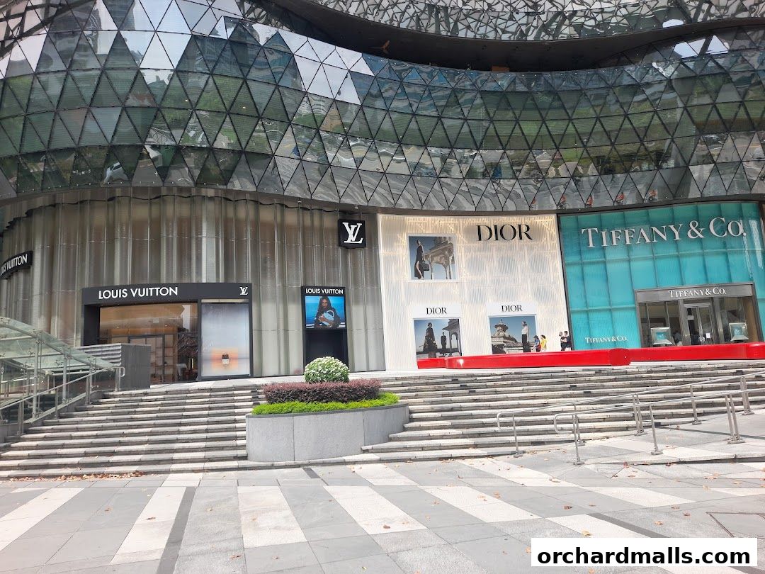 Exterior view of luxury brand stores including Louis Vuitton, Dior, and Tiffany & Co.