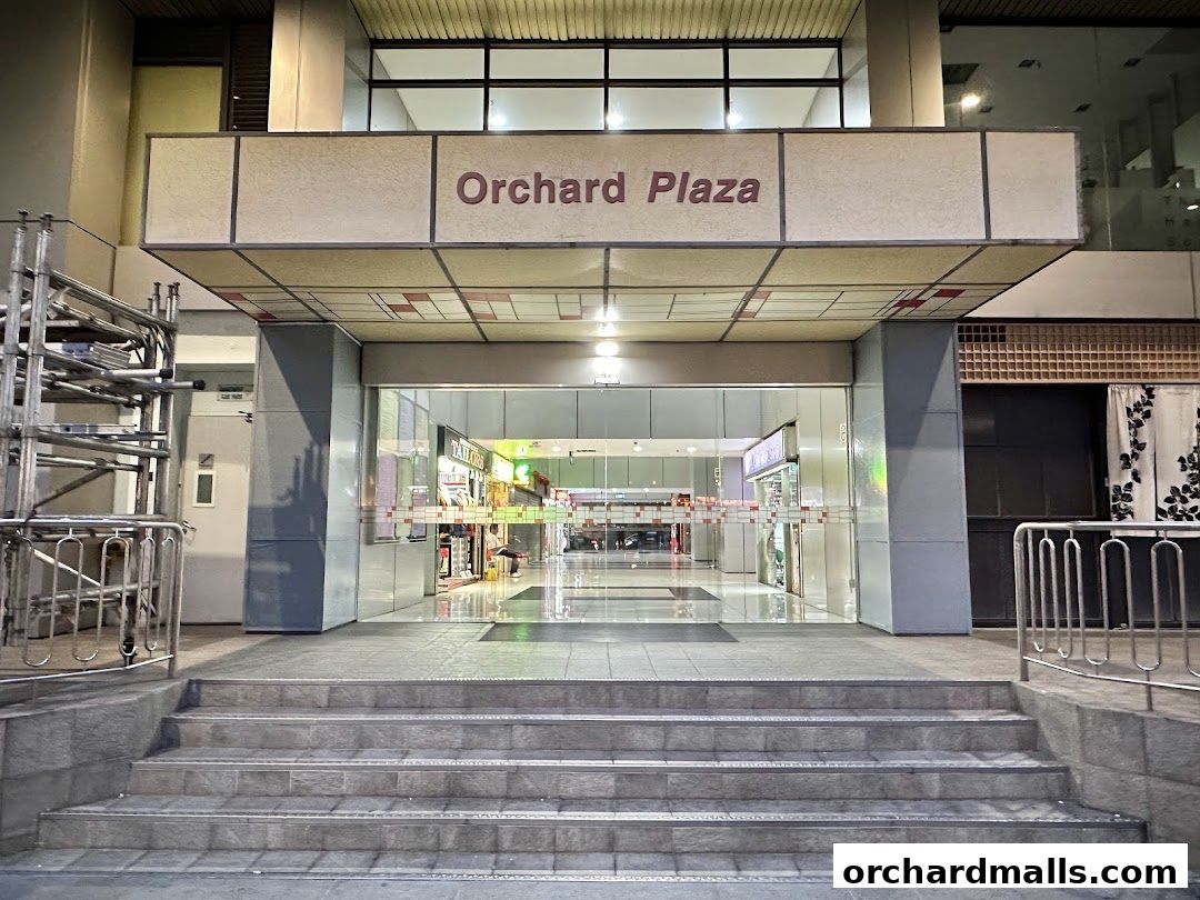 Entrance to Orchard Plaza with shops visible inside.