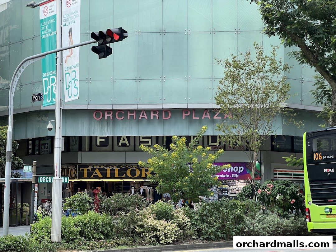 Orchard Plaza building facade with various shops including a tailor and a gift shop.