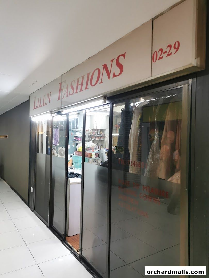 The storefront of Lilen Fashions, displaying clothing and a sign with contact information.