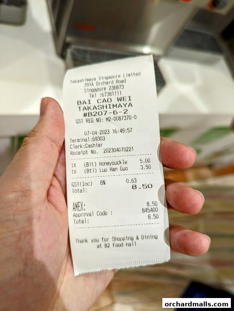 A receipt from Bai Cao Wei Takashimaya showing purchased items and total cost.