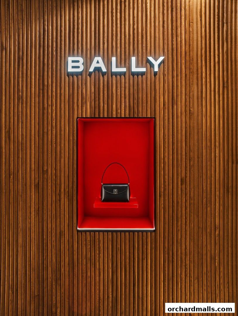 Bally logo above a display of a black handbag in a red niche.