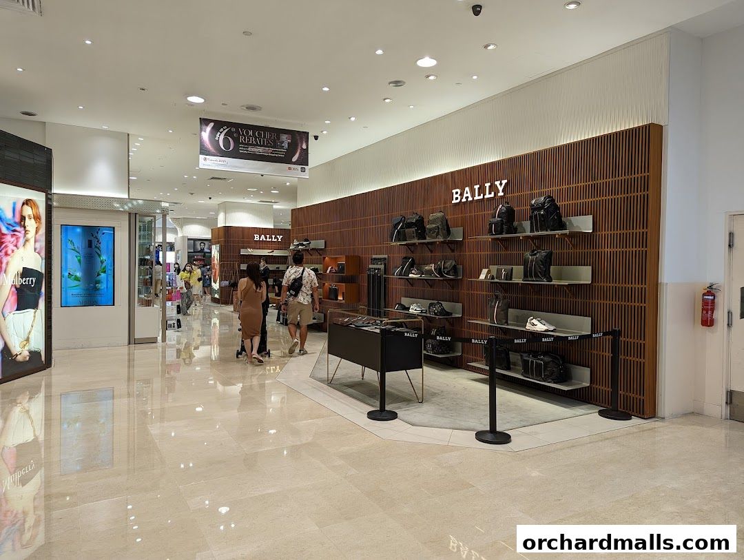 Interior view of a Bally store showcasing handbags, shoes, and accessories on display.