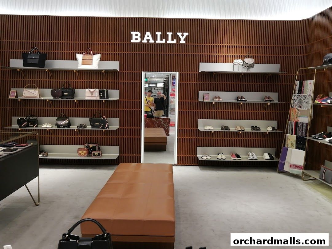 Interior of a Bally store showcasing handbags, shoes, and accessories on display shelves.