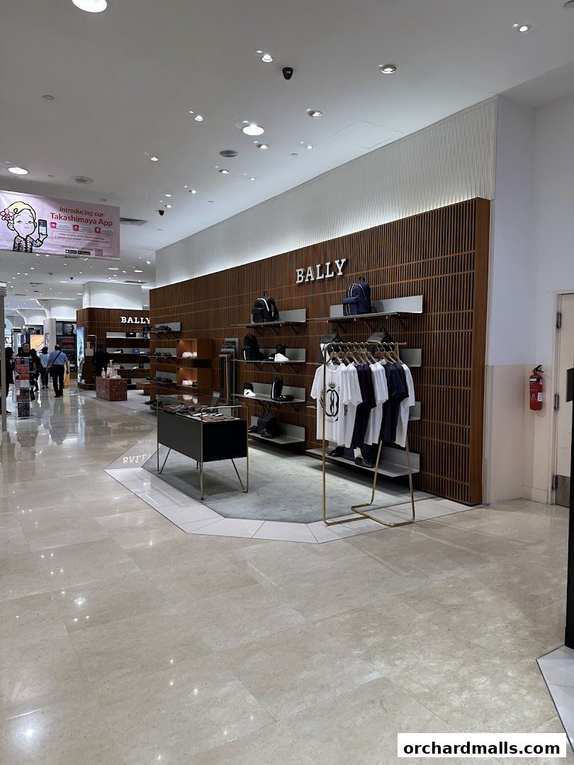 Interior view of a Bally store showcasing handbags, shoes, and apparel on display.