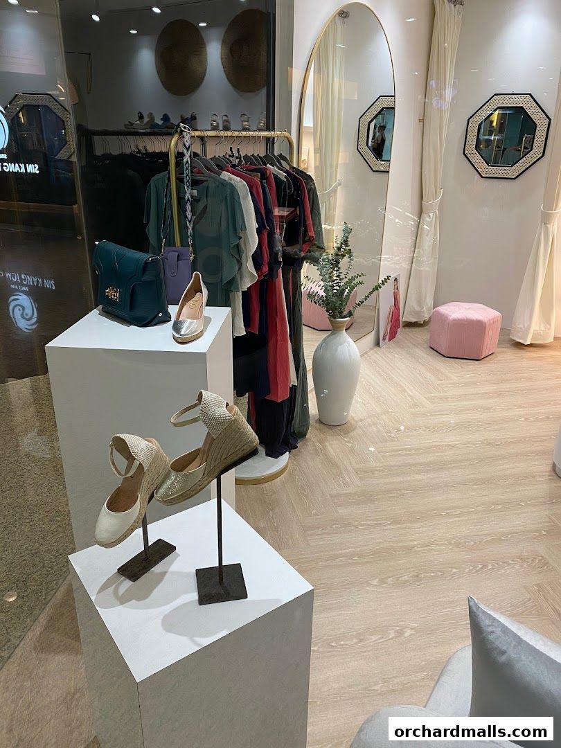 A stylish boutique display featuring women's shoes, handbags, and clothing.