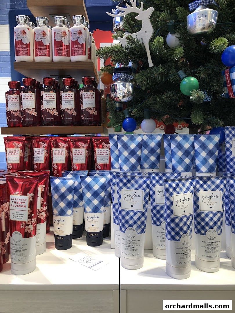Bath & Body Works display featuring Japanese Cherry Blossom and Gingham body washes with a festive Christmas tree.