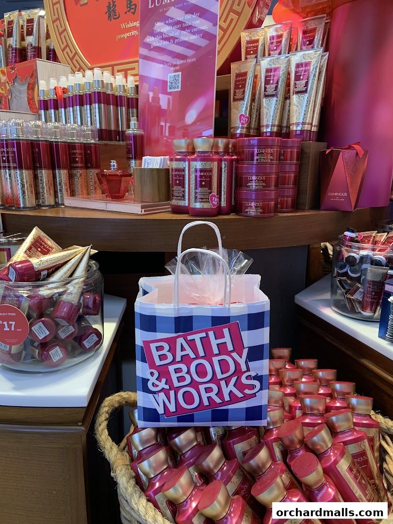 A display of Bath & Body Works products, including lotions and body care items, with prominent branding.
