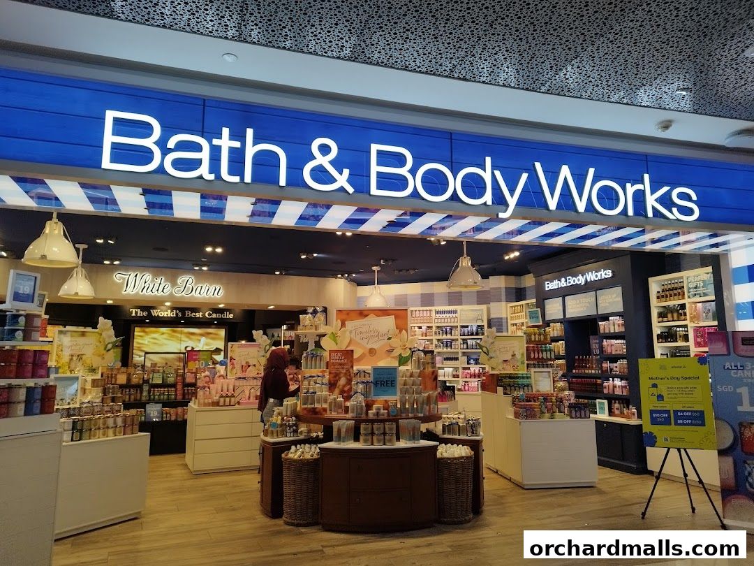 The brightly lit interior of a Bath & Body Works store, showcasing various products and displays.
