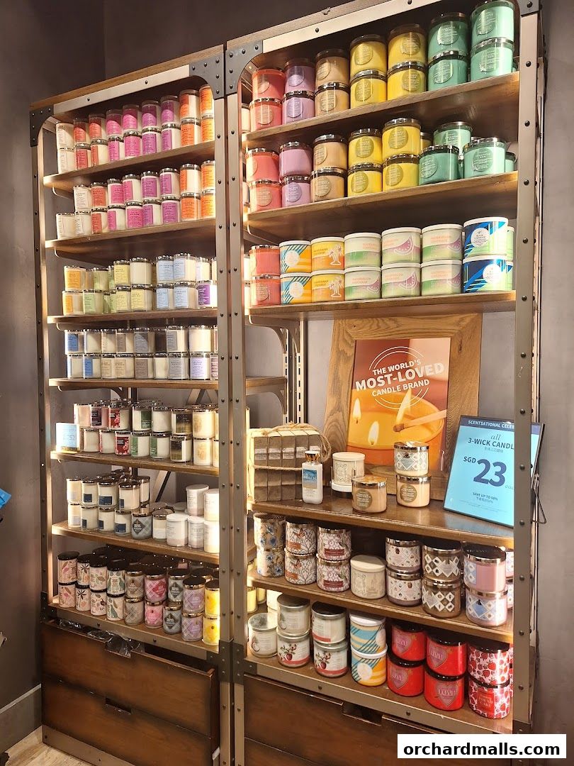Shelves filled with a wide variety of scented candles in different sizes and colors.