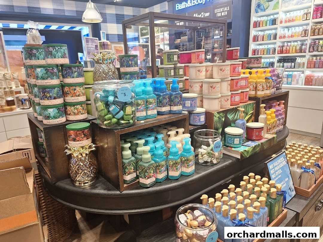A display of Bath & Body Works products including candles, soaps, and hand sanitizers.