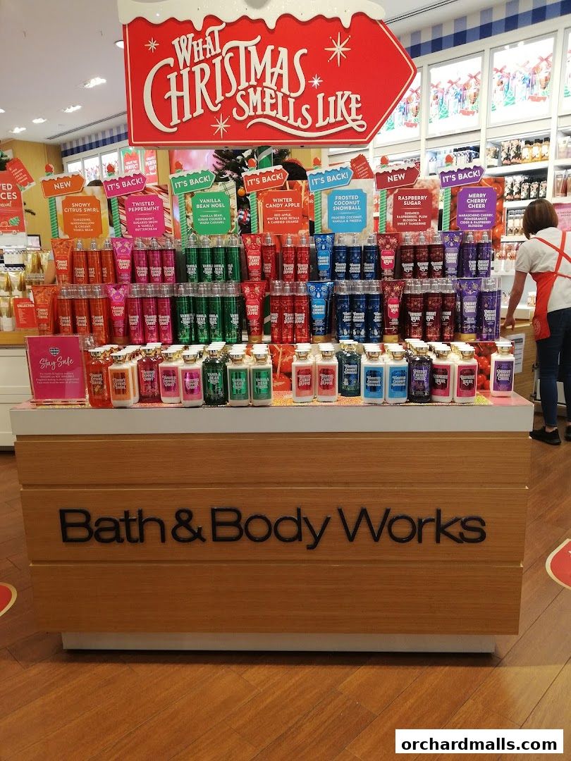 Bath & Body Works display featuring Christmas-themed scents and body care products.