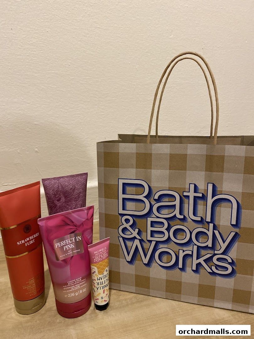 Bath & Body Works products and shopping bag displayed against a wall.