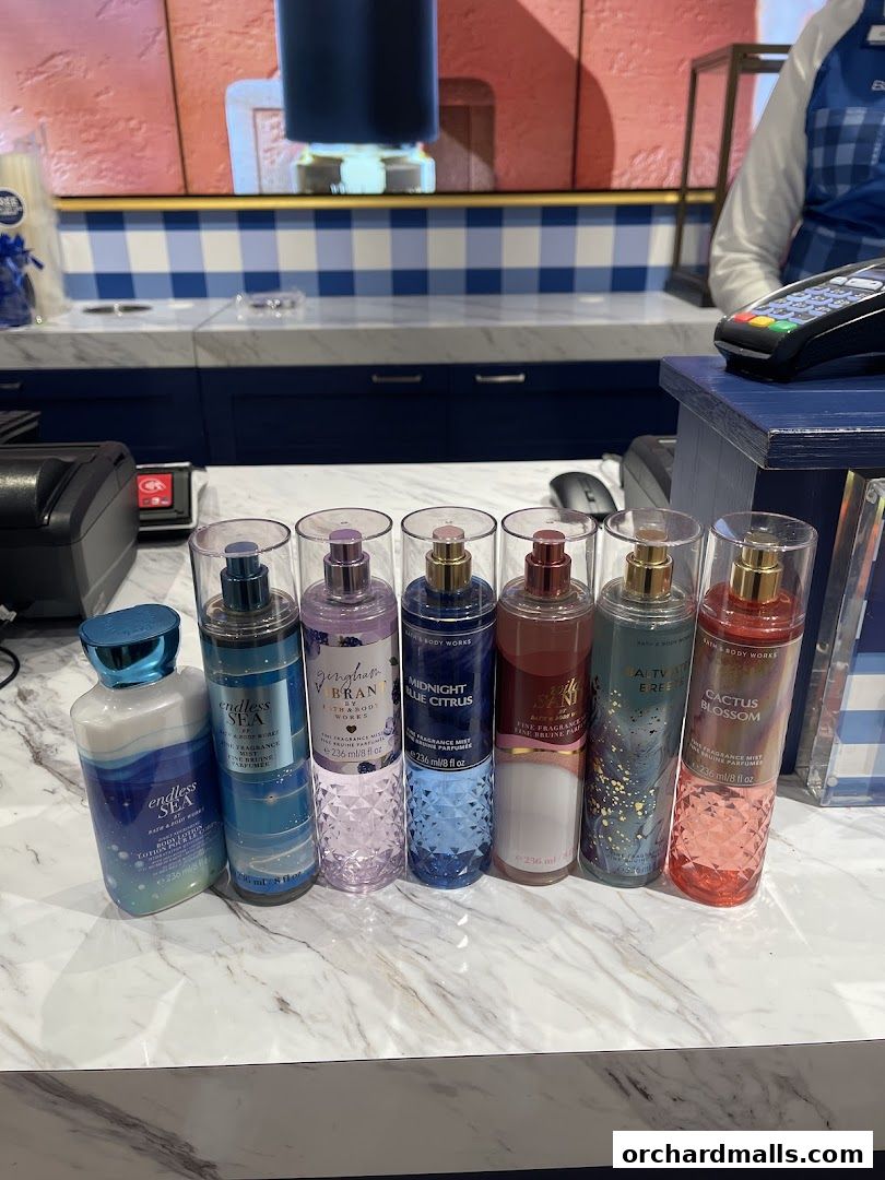 A selection of Bath & Body Works body lotions and fine fragrance mists displayed on a counter.