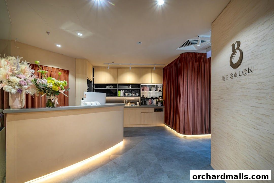 Interior view of Be Salon Wheelock Orchard, featuring a reception desk, floral arrangements, and product displays.