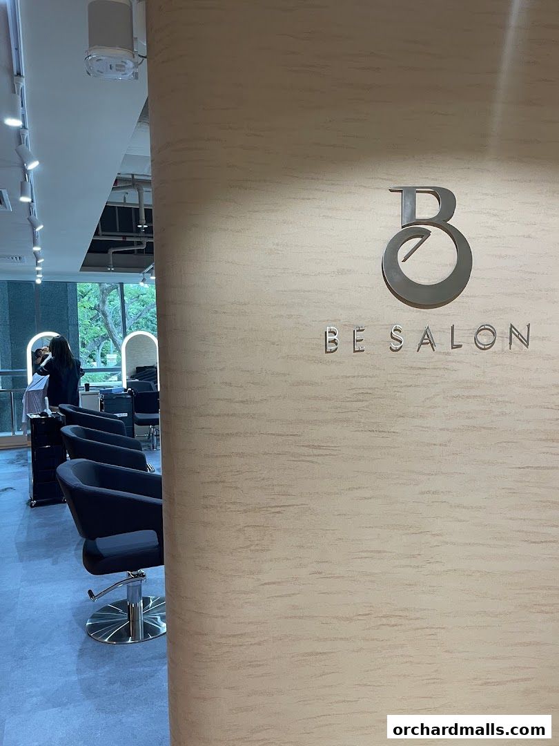 Interior view of Be Salon Wheelock Orchard with styling chairs and a logo.