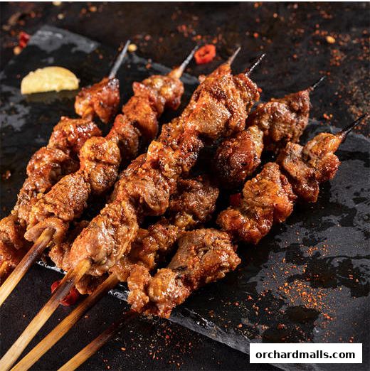 Close-up of delicious grilled meat skewers seasoned with spices.