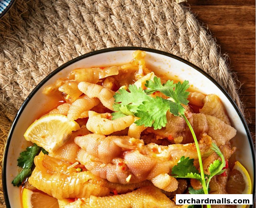 A close-up shot of a bowl of delicious chicken feet with lemon and cilantro.