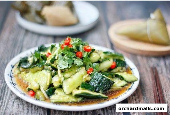 A plate of sliced cucumbers with chili and cilantro, served with chopsticks.