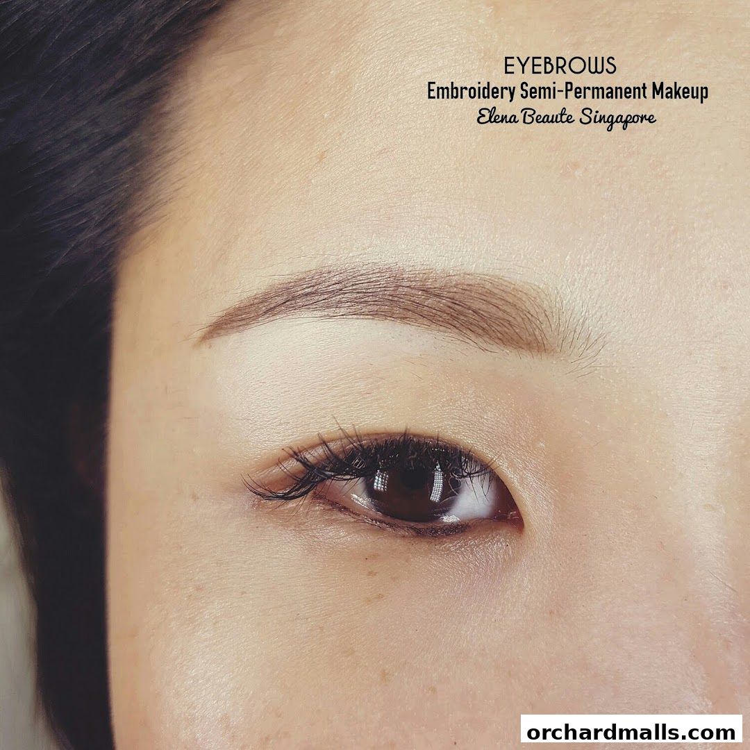 Close-up of a woman's eye showcasing beautifully embroidered semi-permanent eyebrows.